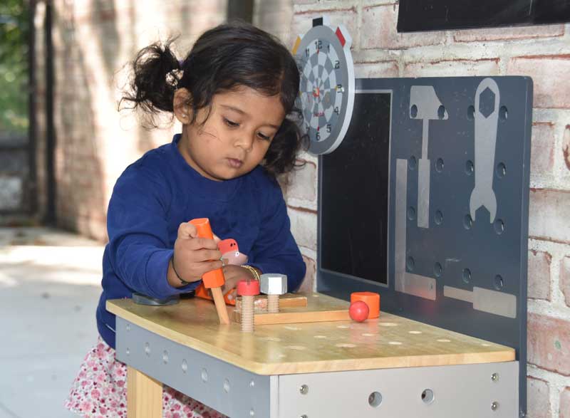 Elisabeth Morrow School student engages with wooden learning toys.