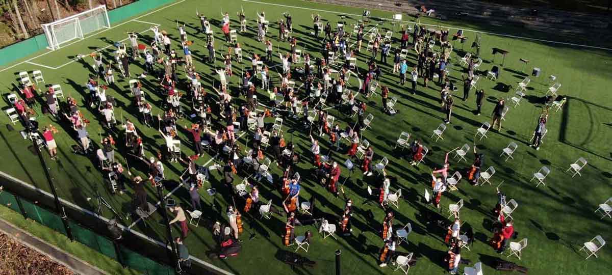 image of strings players on the field of Elisabeth Morrow School during the COVID-19 school year