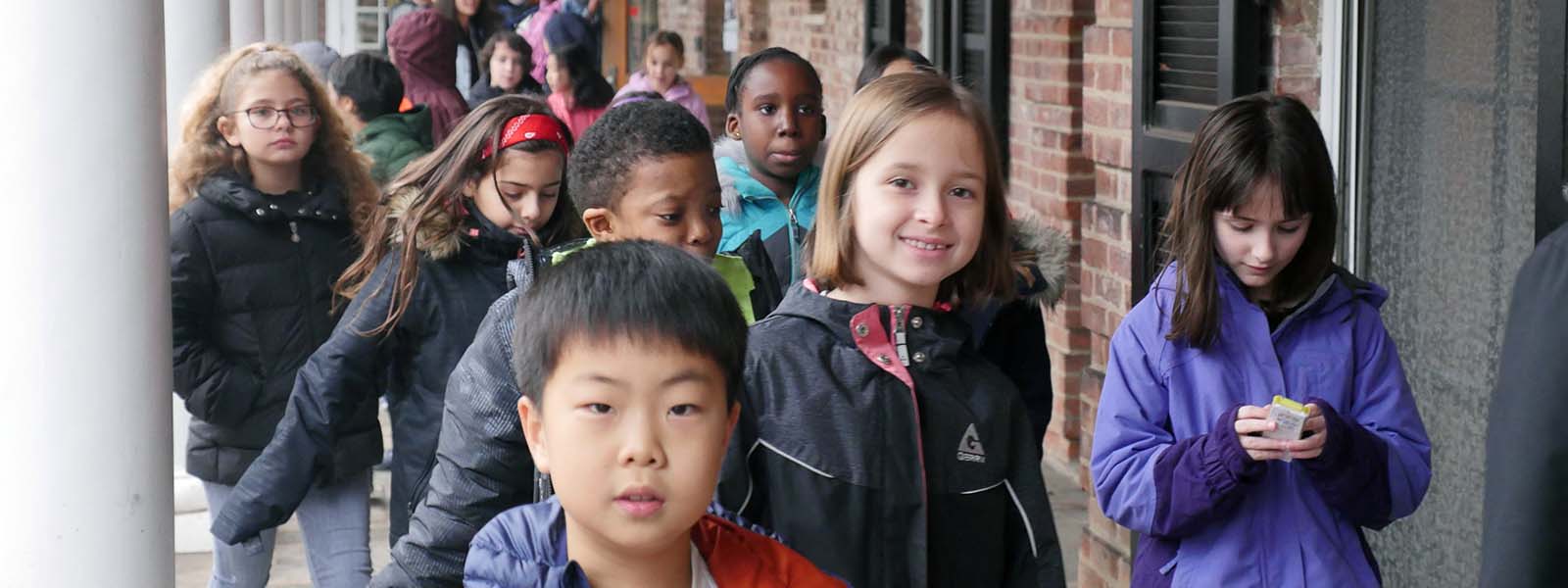 Little School Students in a line waiting to walk into a classroom at The Elisabeth Morrow School